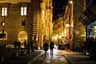 Ludzie spacerują wieczorem historyczną ulicą Florencji wśród zabytkowych budynków, gdy rynek złota spokojnie czeka na podwyżkę Fed.